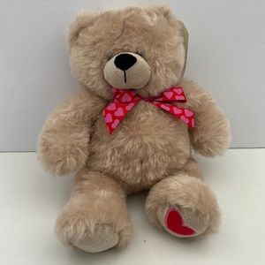 Hands on a GANZ cream Teddy bear stuffed animal